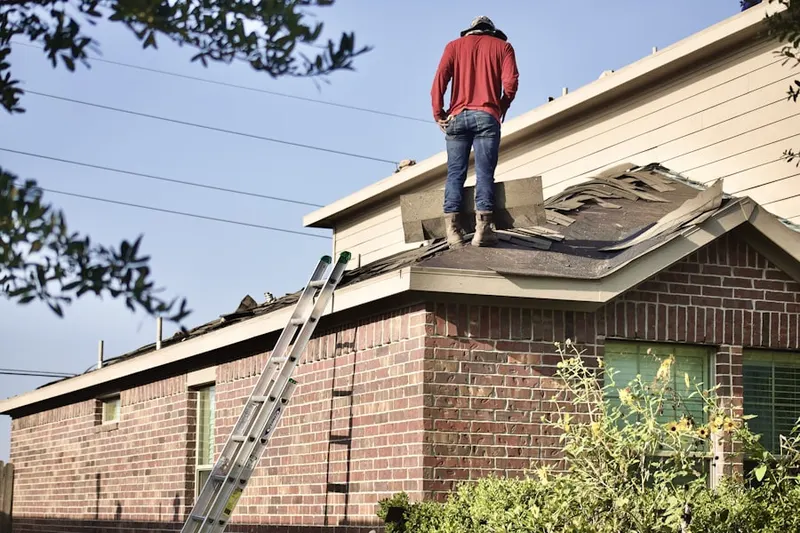 Professional roofer working on a residential roof in Driftwood Mobile Home Park